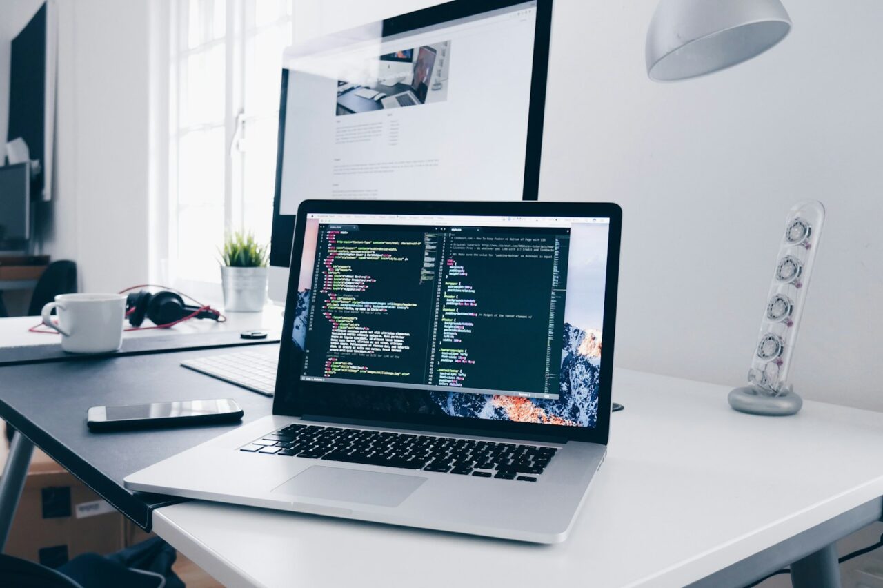 Modern thin laptop open on a wooden desk in a bright home workspace