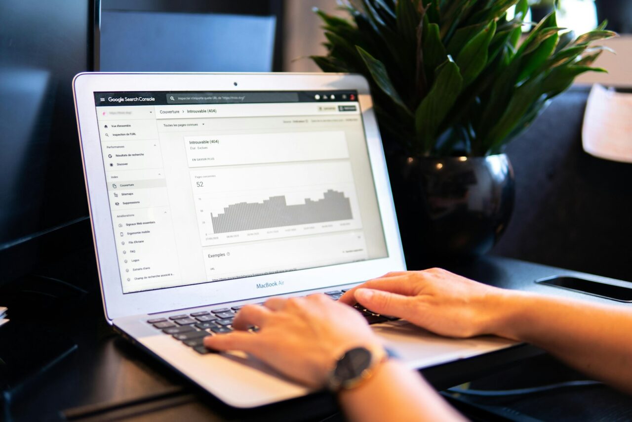 Laptop screen showing website search traffic analytics on an office desk