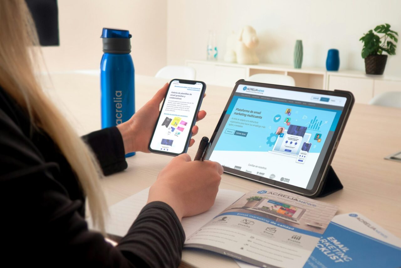 Marketer drafting an email newsletter on a laptop in a bright workspace