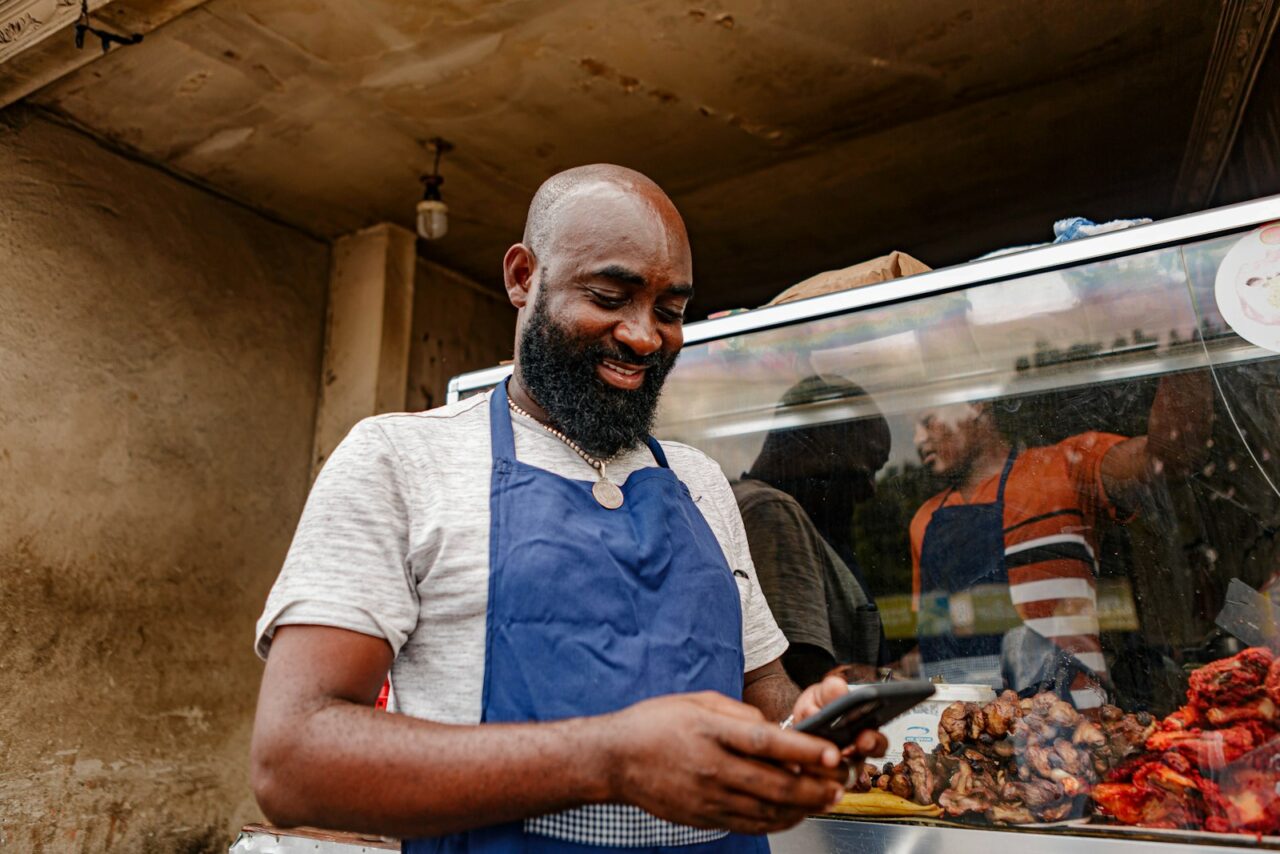Small business owner reviewing finances and growth plans at a shop counter