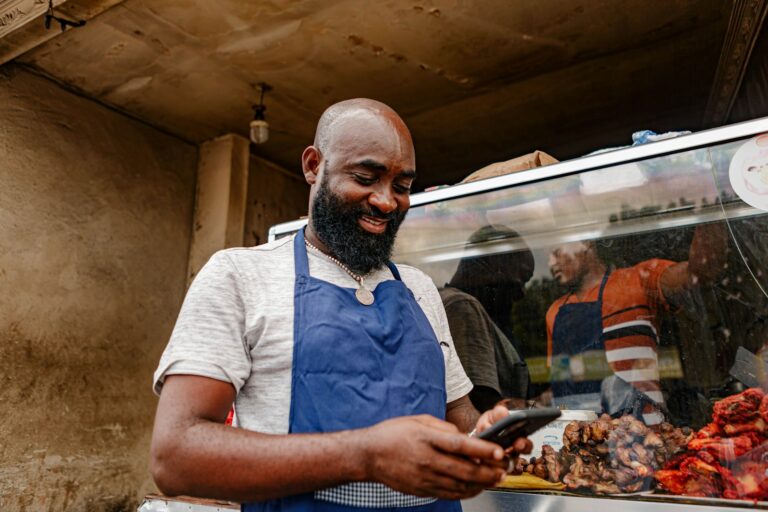 Small business owner reviewing finances and growth plans at a shop counter
